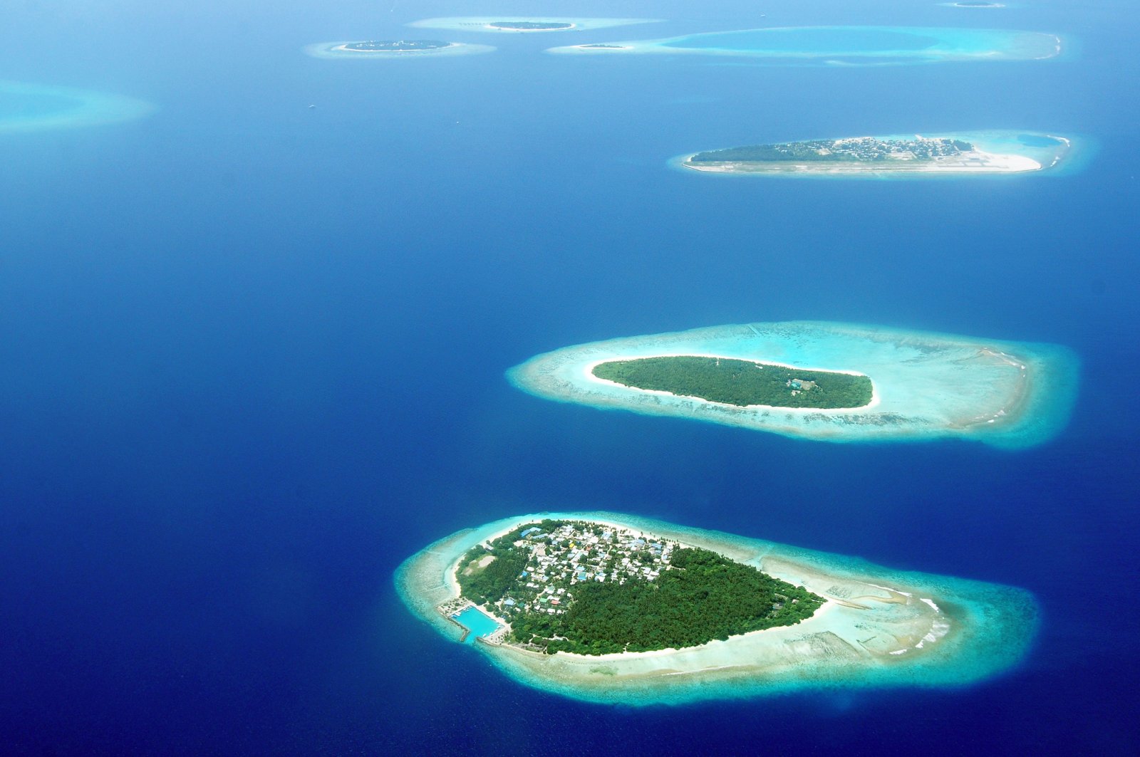 Aerial view of Maldives islands and reef waters